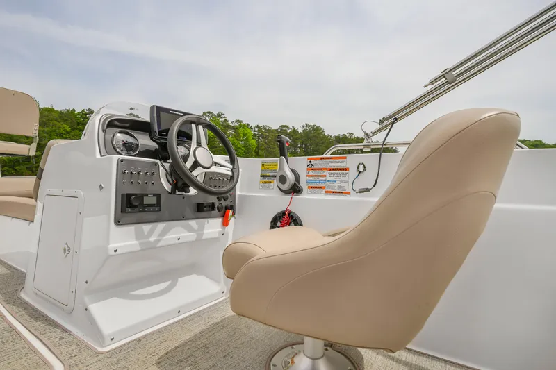 Slide: The Image of 2022 Hurricane SS201 boat interior with steering wheel and beige captain's chair. - 7
