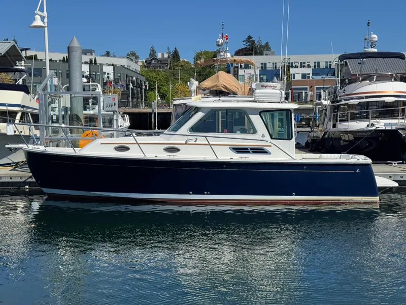 The Image of 2008 Back Cove 29 Hardback boat docked at marina, named "Change of Pace." - 0