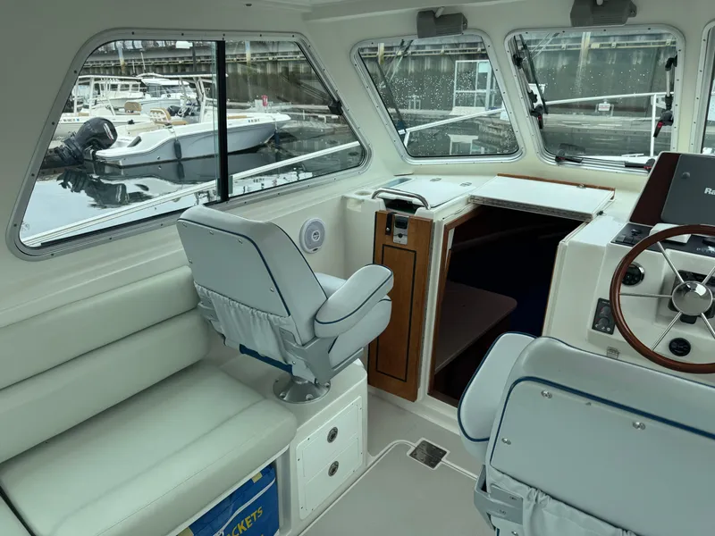 Slide: The Image of 2008 Back Cove 29 Hardback boat docked in a marina, featuring a sleek blue hull. - 10