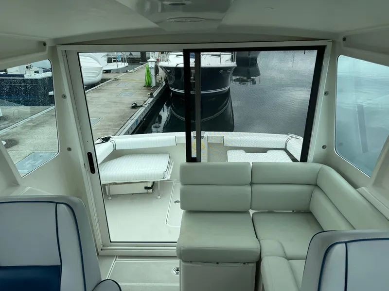 Slide: The Image of 2008 Back Cove 29 Hardback boat docked at a marina under cloudy skies. - 12