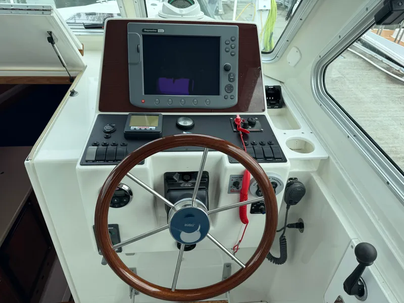 Slide: The Image of 2008 Back Cove 29 Hardback boat docked in a marina, surrounded by other vessels. - 13