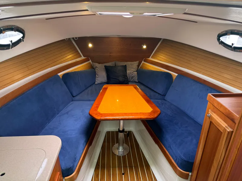 Slide: The Image of 2008 Back Cove 29 Hardback boat docked, available for sale, with overcast sky in the background. - 14