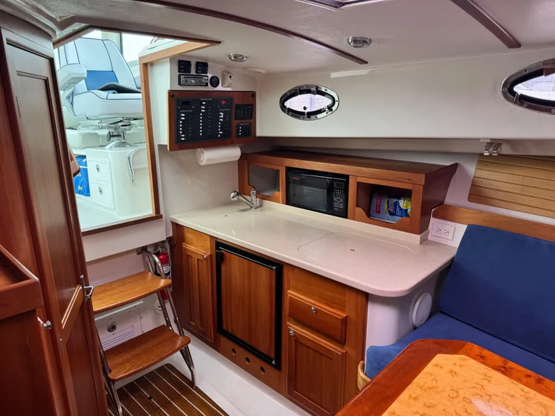 Slide: The Image of 2008 Back Cove 29 Hardback boat interior with steering wheel and navigation equipment. - 15