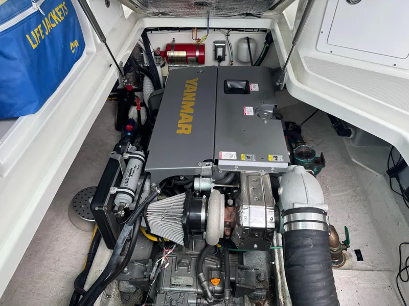 Slide: The Image of 2008 Back Cove 29 Hardback helm with steering wheel and navigation controls. - 19