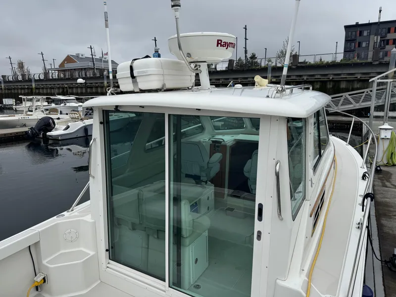 Slide: The Image of Interior of 2008 Back Cove 29 Hardback boat with kitchenette and seating area. - 21