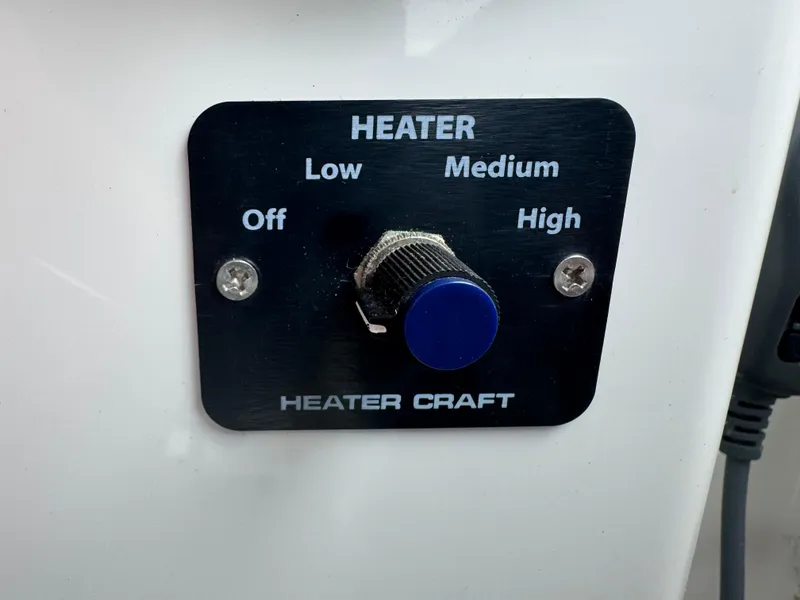 Slide: The Image of Interior of 2008 Back Cove 29 Hardback boat with wooden cabinetry and blue seating. - 22