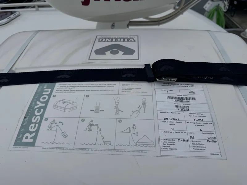 Slide: The Image of 2008 Back Cove 29 Hardback boat docked, featuring a glass-enclosed cabin and Raymarine radar. - 27