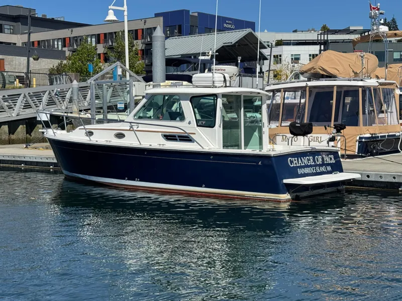 Slide: The Image of 2008 Back Cove 29 Hardback boat docked at marina, blue hull, white cabin. - 3