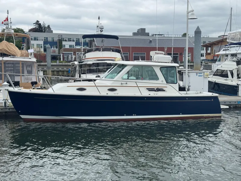 Slide: The Image of 2008 Back Cove 29 Hardback boat docked at marina with sunlit reflections. - 4