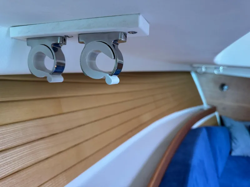 Slide: The Image of Interior of 2008 Back Cove 29 Hardback boat with wooden paneling and metal hooks. - 46
