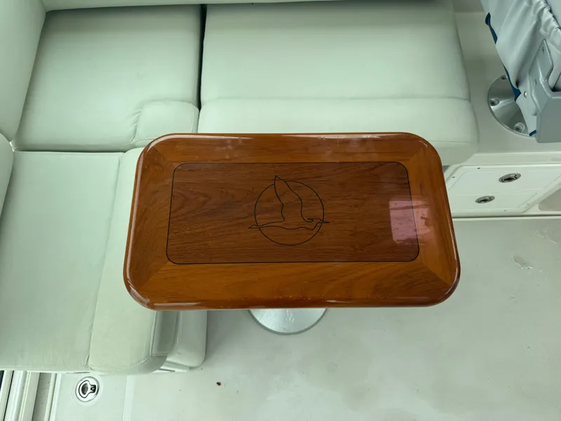 Slide: The Image of 2008 Back Cove 29 Hardback boat interior with wooden table and cushioned seating. - 47