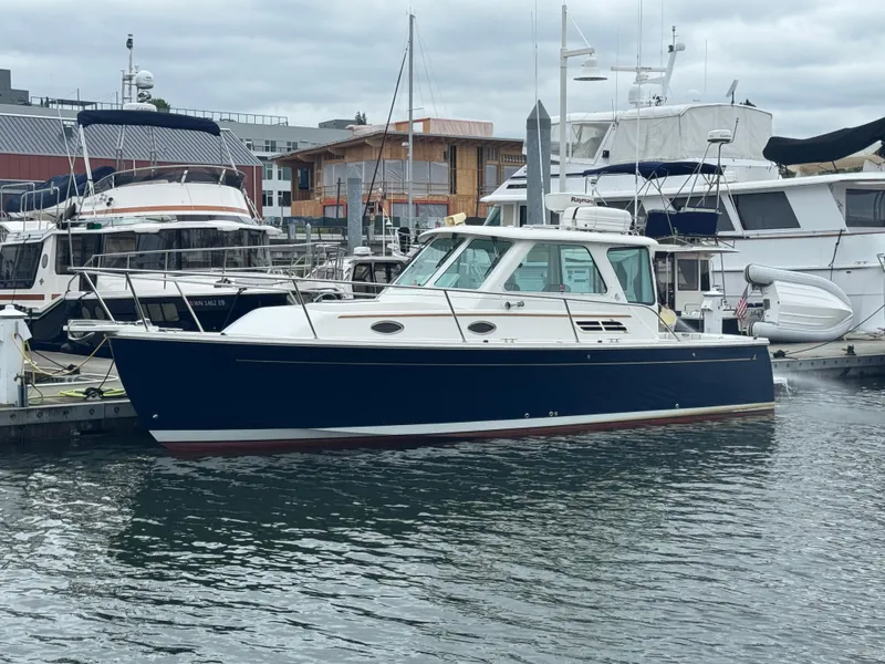 Slide: The Image of 2008 Back Cove 29 Hardback boat docked in a marina, surrounded by other vessels. - 7