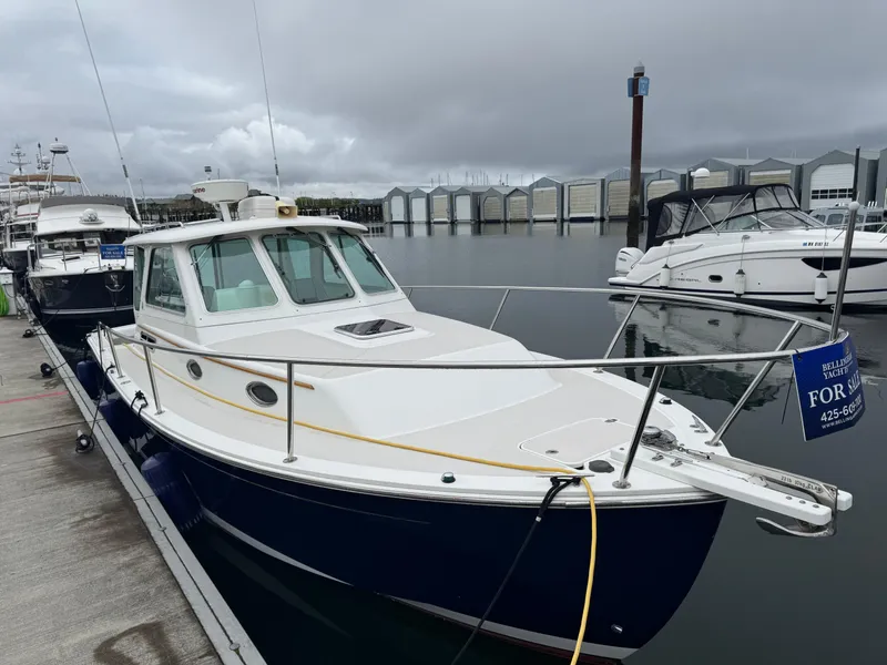 Slide: The Image of 2008 Back Cove 29 Hardback boat docked in a marina under clear blue skies. - 8