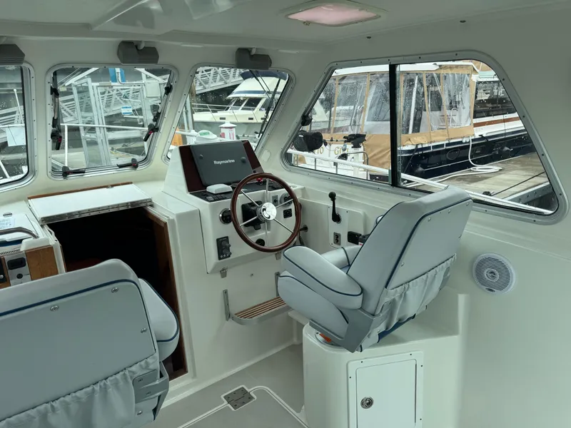 Slide: The Image of 2008 Back Cove 29 Hardback boat docked at a marina, featuring a sleek design. - 9