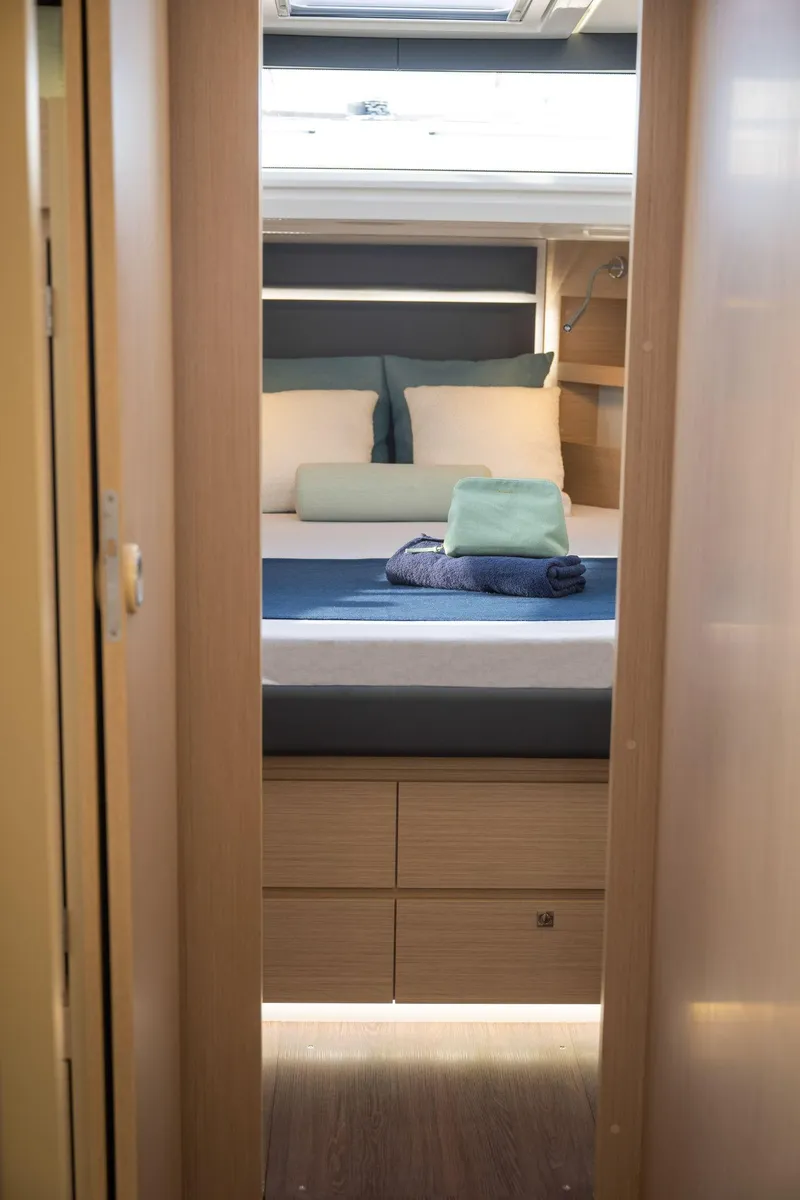 Slide: The Image of Interior cabin of 2025 Delphia D12 Fly yacht, featuring a cozy bed and modern design. - 7