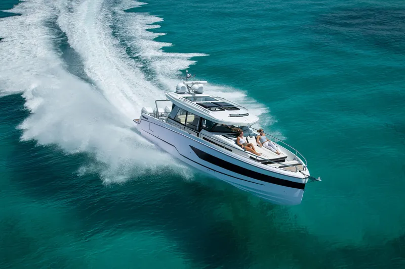 Slide: The Image of 2025 Wellcraft 38 Explorer cruising on clear turquoise waters, showcasing sleek design and speed. - 4