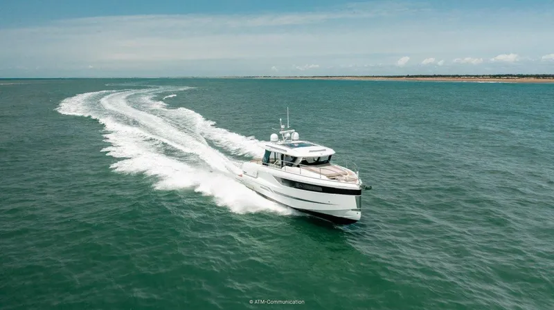 Slide: The Image of 2025 Wellcraft 44 Explorer cruising on open sea, leaving a trail of white waves. - 3