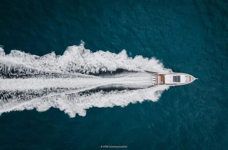 Slide: The Image of Aerial view of 2025 Wellcraft 44 Explorer yacht cruising on blue ocean waters. - 4