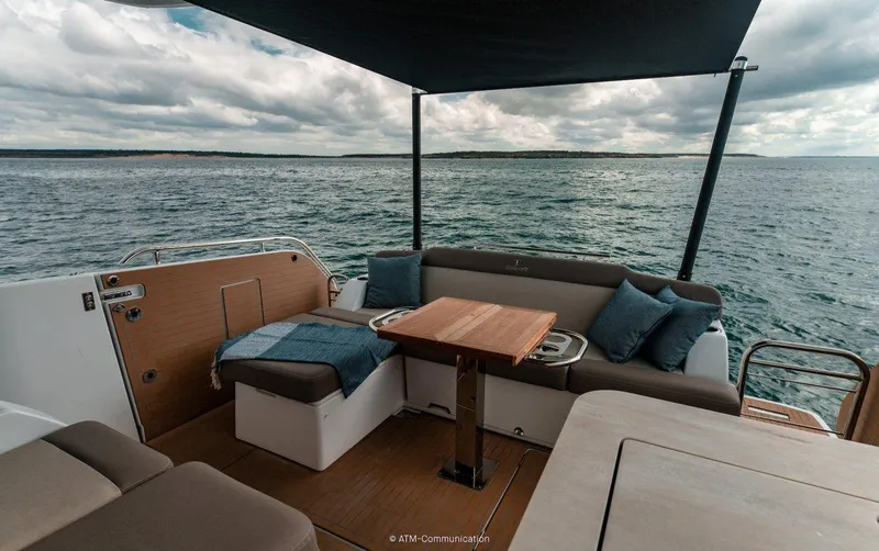 Slide: The Image of Wellcraft 44 Explorer 2025 yacht deck with seating, table, and ocean view. - 9