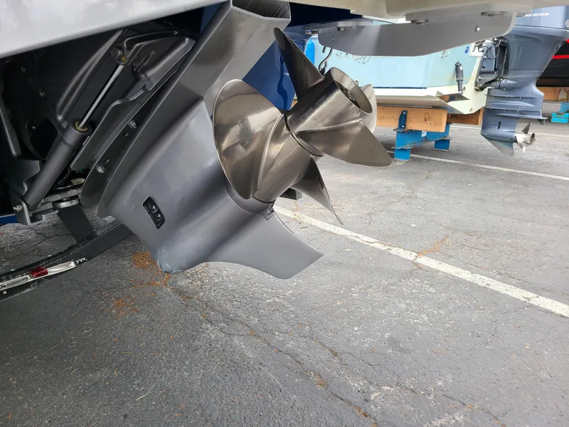 Slide: The Image of 2023 Four Winns H4 boat propeller on display in a parking lot. - 6