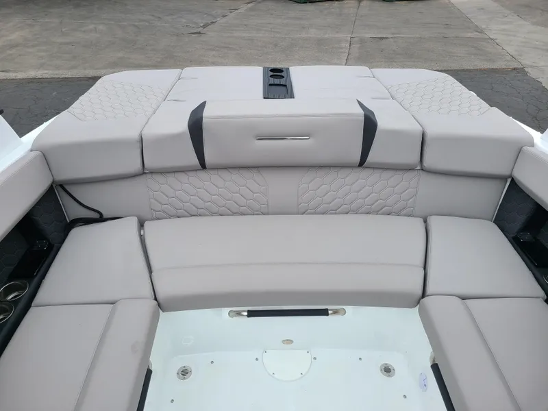 Slide: The Image of 2023 Four Winns H4 boat interior with gray cushioned seating and modern design. - 10