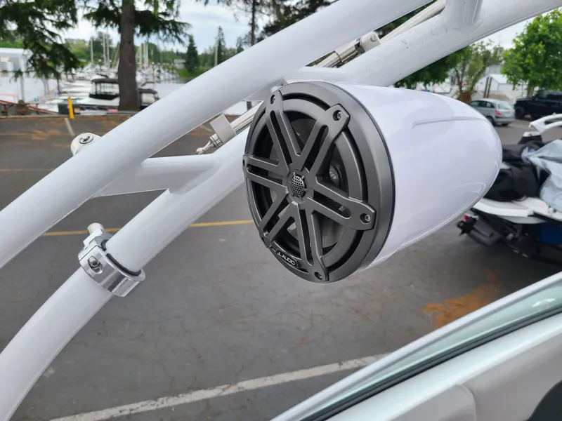 Slide: The Image of 2023 Four Winns H4 boat speaker mounted on a white frame, outdoor setting. - 11