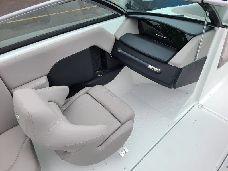 Slide: The Image of 2023 Four Winns H4 boat interior with sleek seating and modern dashboard design. - 12