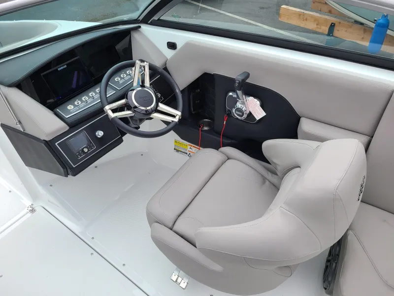 Slide: The Image of 2023 Four Winns H4 boat cockpit with modern steering wheel and controls. - 13