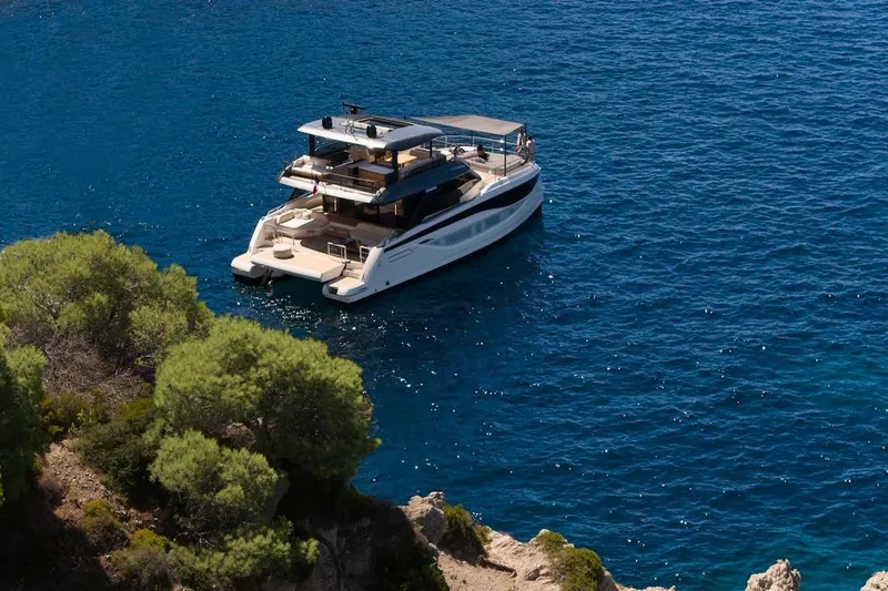 Slide: The Image of Luxury Prestige M7 yacht cruising in clear blue waters, 2025 model. - 104