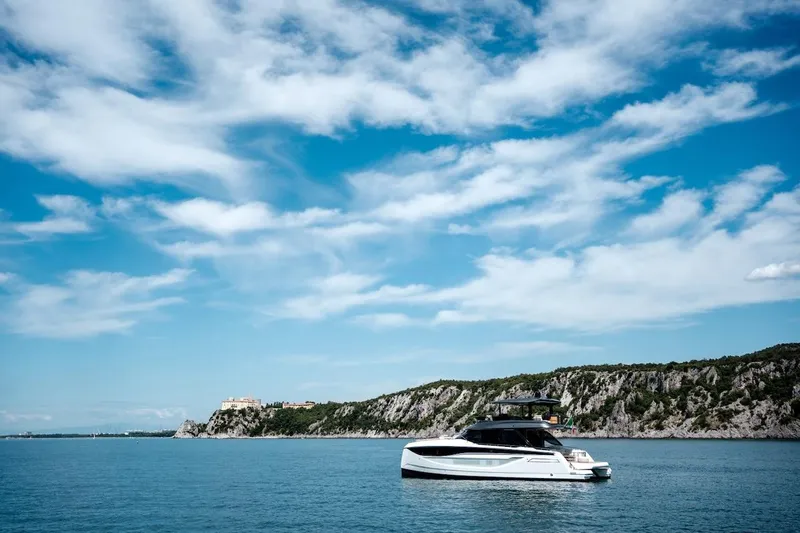 Slide: The Image of Luxury Prestige M7 yacht cruising near scenic coastline under blue sky, 2025 model. - 19