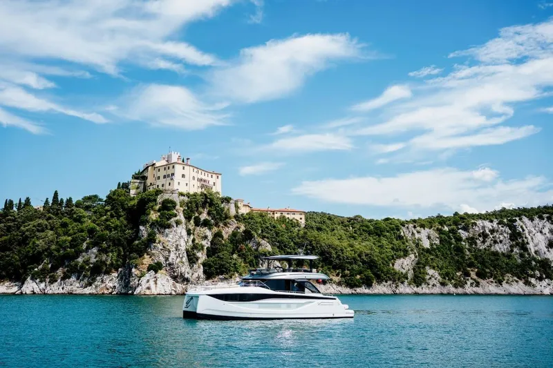 Slide: The Image of Luxury Prestige M7 yacht cruising near scenic coastal cliffs, 2025 model. - 20