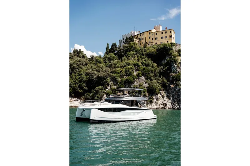 Slide: The Image of Luxury Prestige M7 yacht cruising near scenic coastal cliffs, 2025 model. - 22