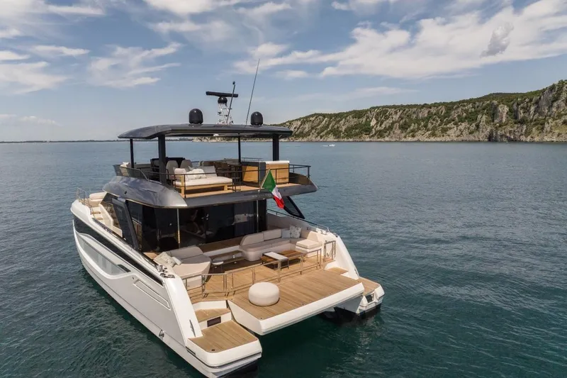 Slide: The Image of Luxurious 2025 Prestige M7 yacht cruising on serene waters near a rocky coastline. - 25