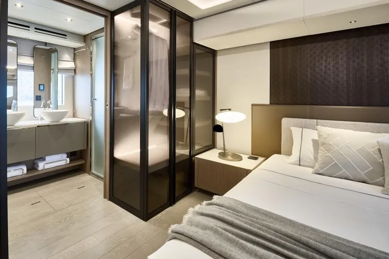 Slide: The Image of Luxurious Prestige M7 2025 yacht bedroom with modern design, ensuite bathroom, and elegant decor. - 33