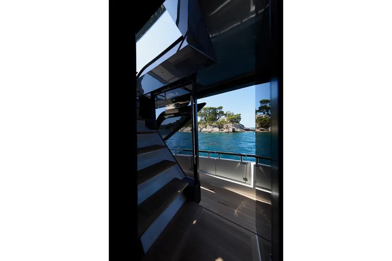Slide: The Image of Interior view of Prestige M7 yacht, showcasing stairs and ocean scenery, 2025 model. - 46