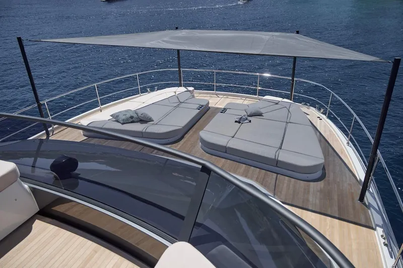 Slide: The Image of Luxury sun deck on 2025 Prestige M7 yacht with cushioned loungers and canopy. - 51