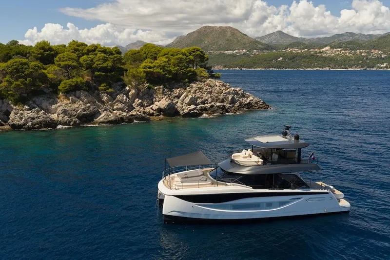 Slide: The Image of Luxury Prestige M7 yacht cruising near scenic rocky coastline, 2025 model. - 55