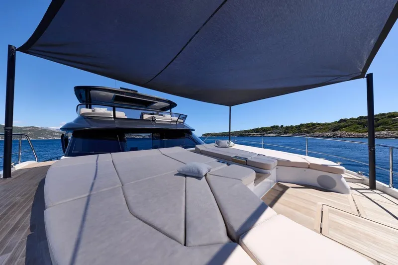 Slide: The Image of Luxurious 2025 Prestige M7 yacht deck with sunshade, overlooking serene blue waters. - 58