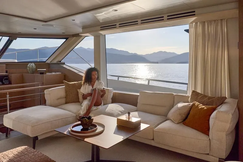 Slide: The Image of Luxurious Prestige M7 yacht interior with woman relaxing, scenic ocean view, 2025 model. - 72
