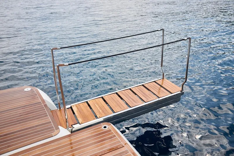 Slide: The Image of Luxury yacht Prestige M7 2025 with wooden gangway over calm water. - 80