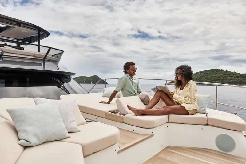 Slide: The Image of Couple relaxing on a 2025 Prestige M7 yacht, enjoying a sunny day at sea. - 84