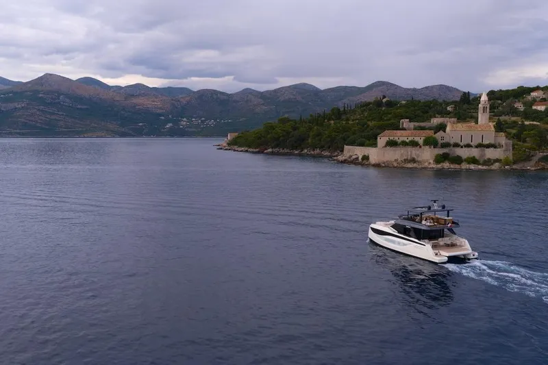 Slide: The Image of Luxury Prestige M7 yacht cruising near scenic coastline, 2025 model. - 87