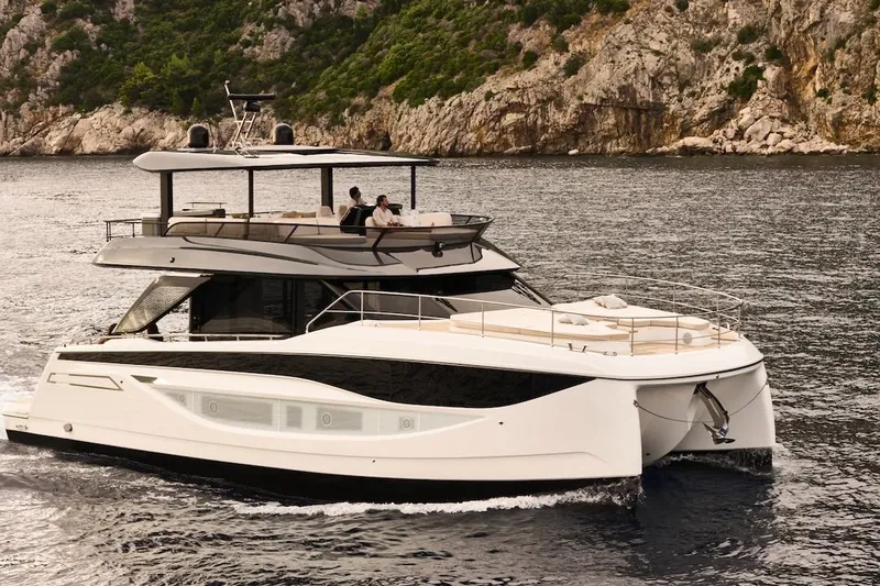 Slide: The Image of Luxury Prestige M7 yacht cruising near rocky coastline, 2025 model. - 91
