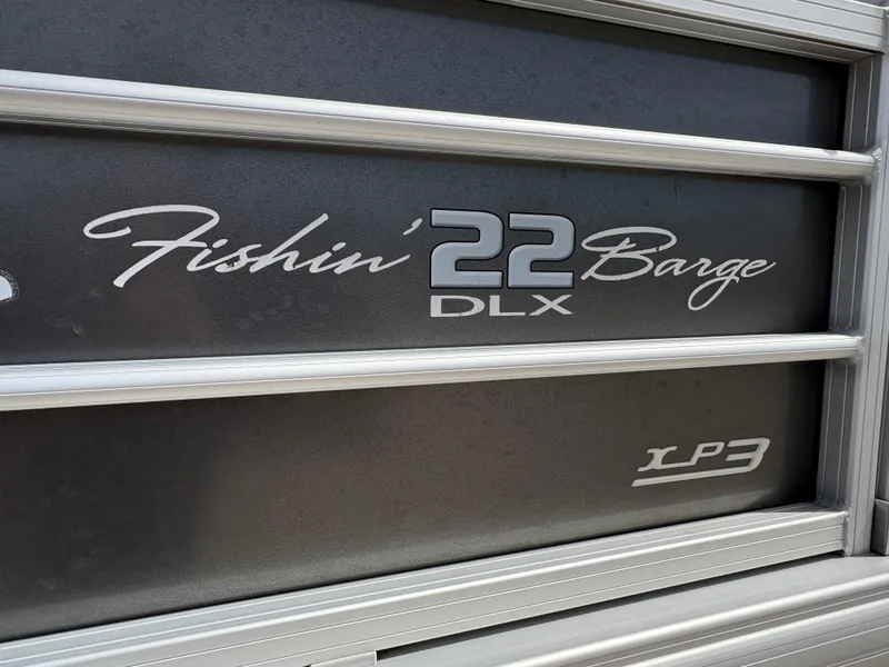 Slide: The Image of 2017 Sun Tracker Fishin' Barge 22 DLX logo on boat exterior. - 6