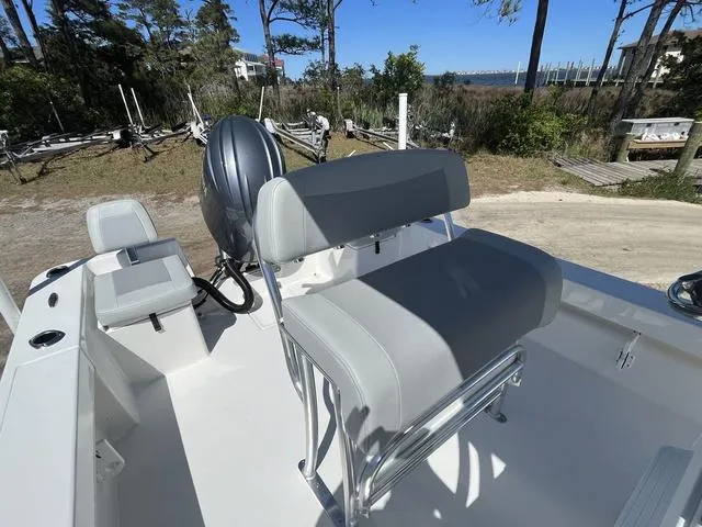 Slide: The Image of 2025 Bay Rider 239 Bay boat interior with seating and motor, outdoors. - 10