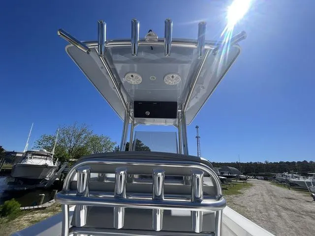 Slide: The Image of 2025 Bay Rider 239 Bay boat with T-top under clear blue sky. - 12