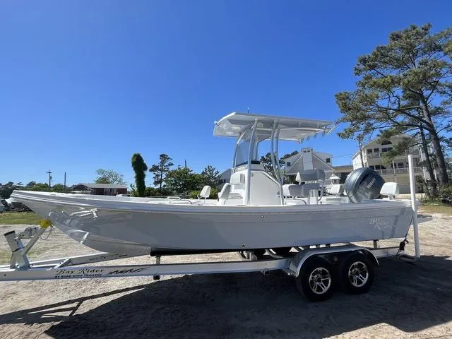 Slide: The Image of 2025 Bay Rider 239 Bay boat on trailer under clear blue sky. - 3