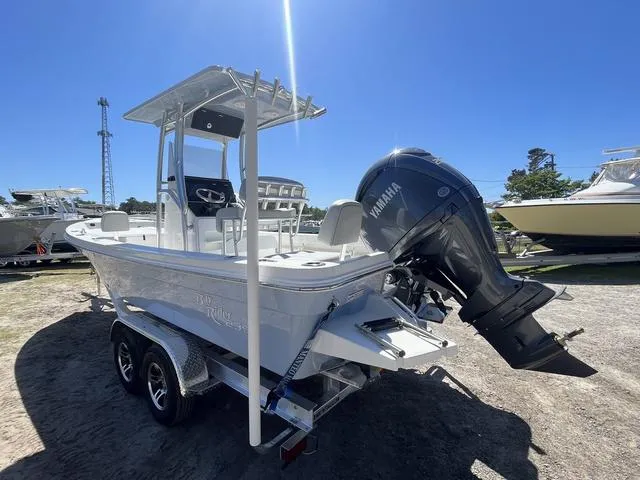 Slide: The Image of 2025 Bay Rider 239 Bay boat with Yamaha outboard engine on a trailer, under clear blue sky. - 4