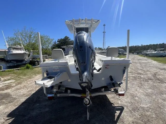 Slide: The Image of 2025 Bay Rider 239 Bay boat with powerful outboard motor, parked on a sunny day. - 5