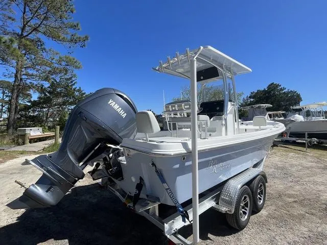 Slide: The Image of 2025 Bay Rider 239 Bay boat with Yamaha engine on trailer, parked outdoors. - 6